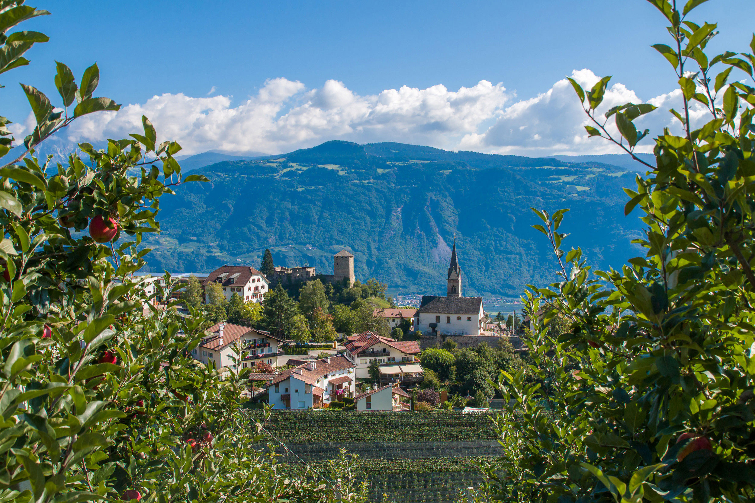 Surrounded by orchards and vineyards, the small village of Völlan with the St. Magdalena church.