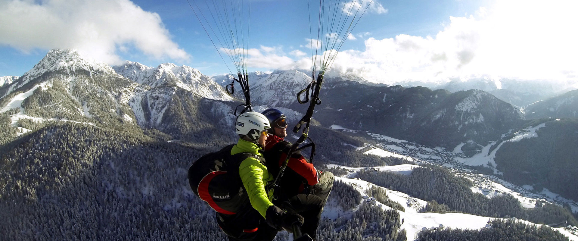 Paragliding over mount Kronplatz in winter. Tandem paragliding over mount Kronplatz Plan in winter.