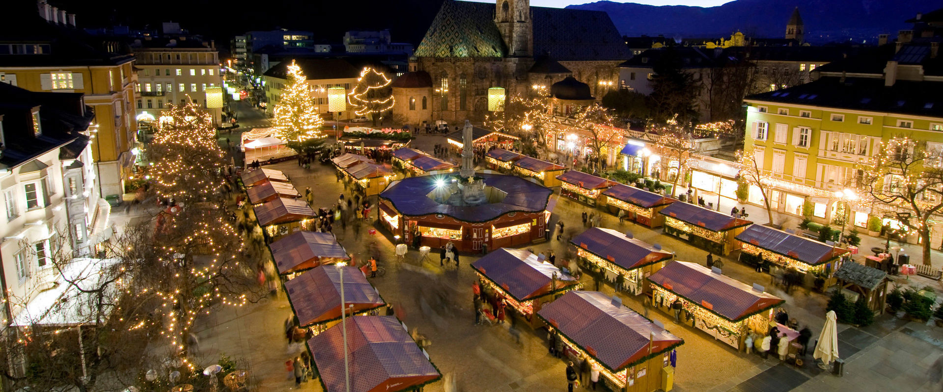 Bozen Christmas market with cathedral at Waltherplatz Square in Bozen by night
