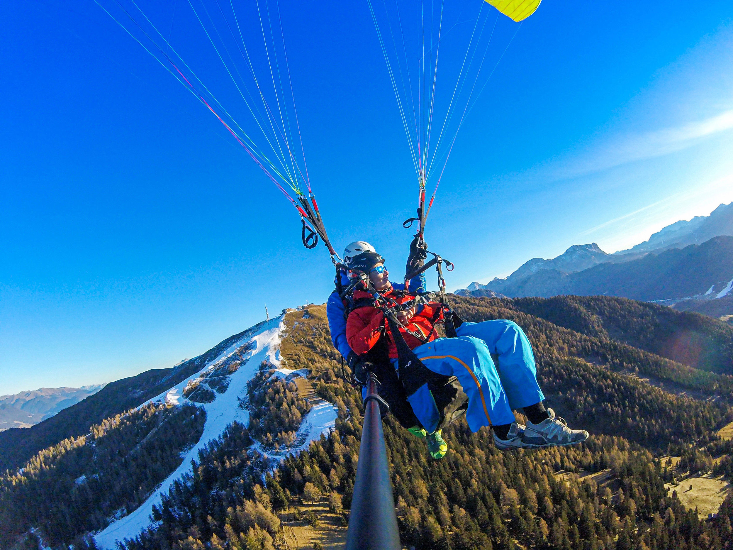 Tandem paragliding over mount Kronplatz Plan in winter.