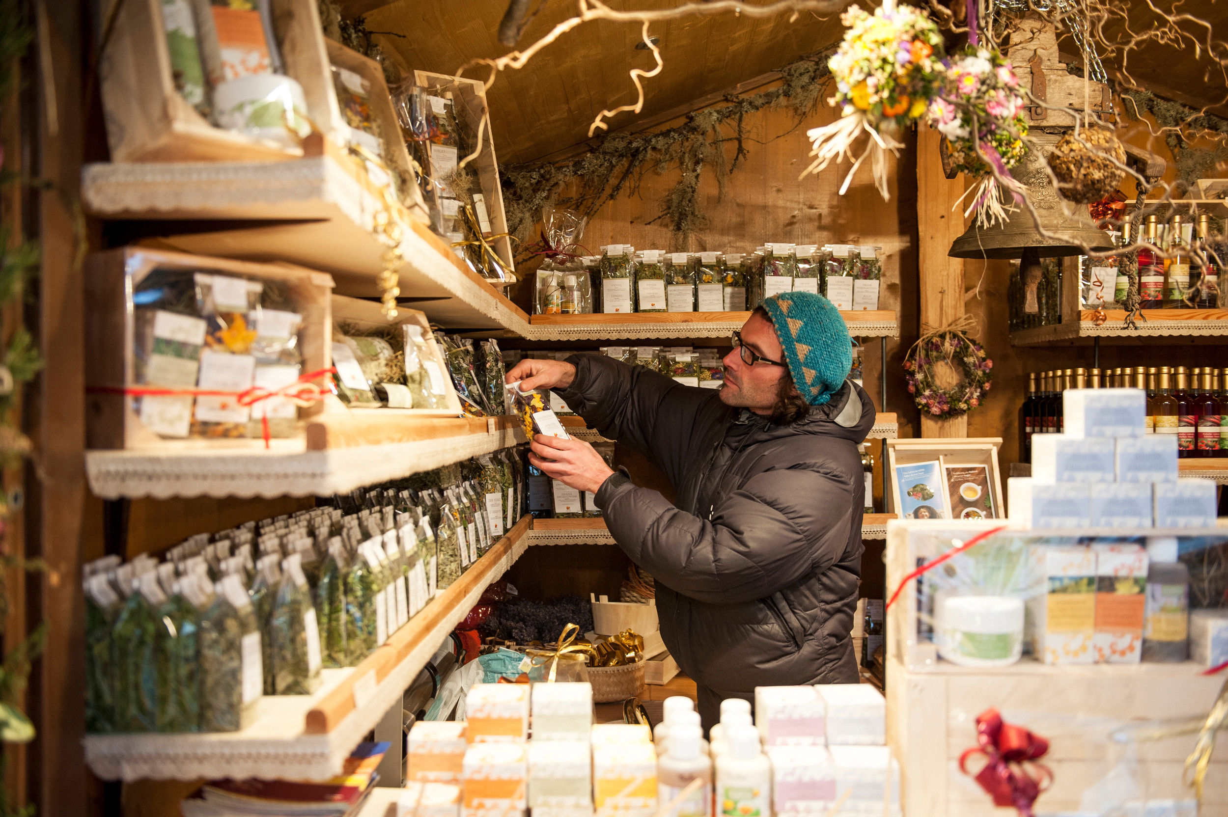 Wooden market stall with various cosmetic items.