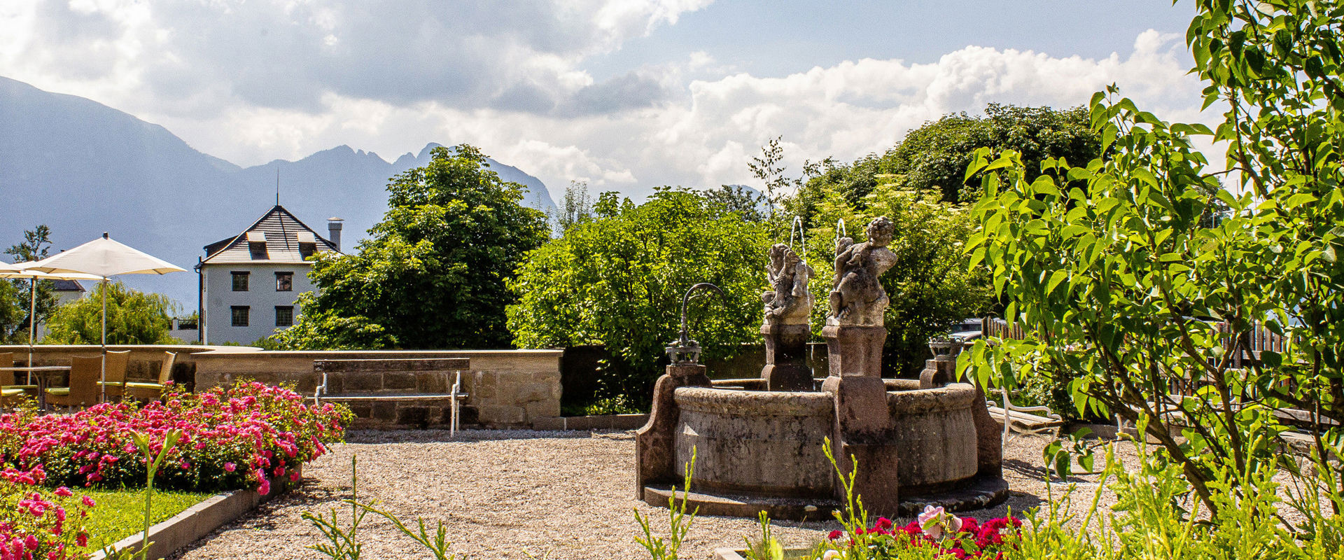 Klobenstein Water fountain and park with flowers in Klobenstein
