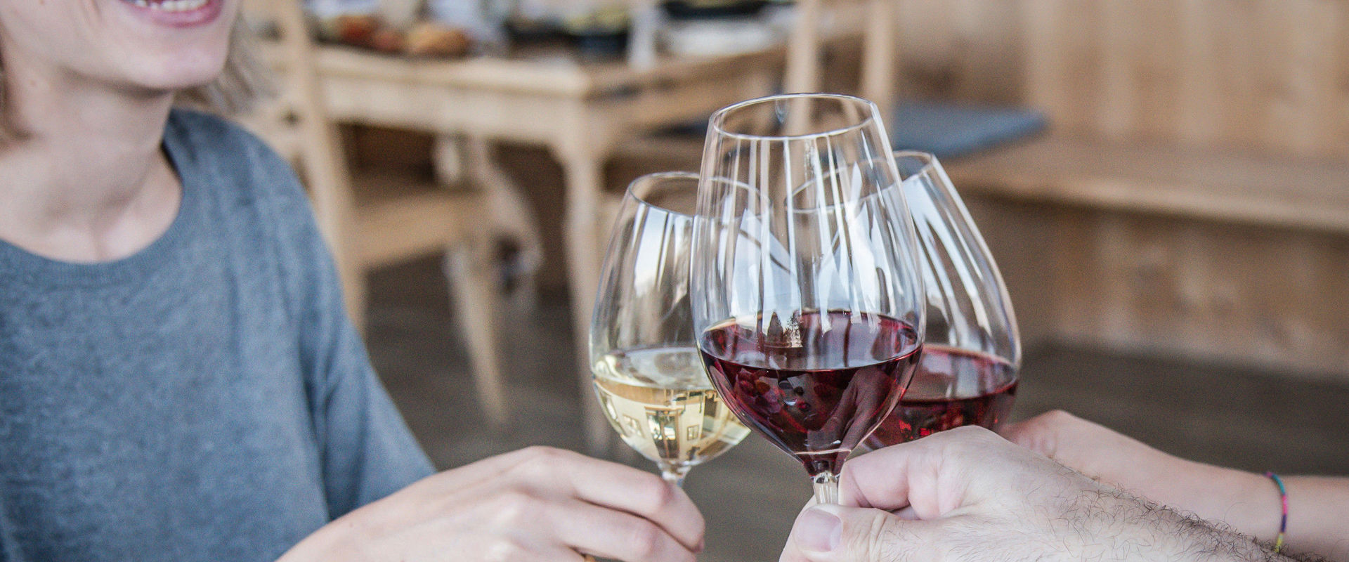 Toast together Friends toast together with a glass of wine.