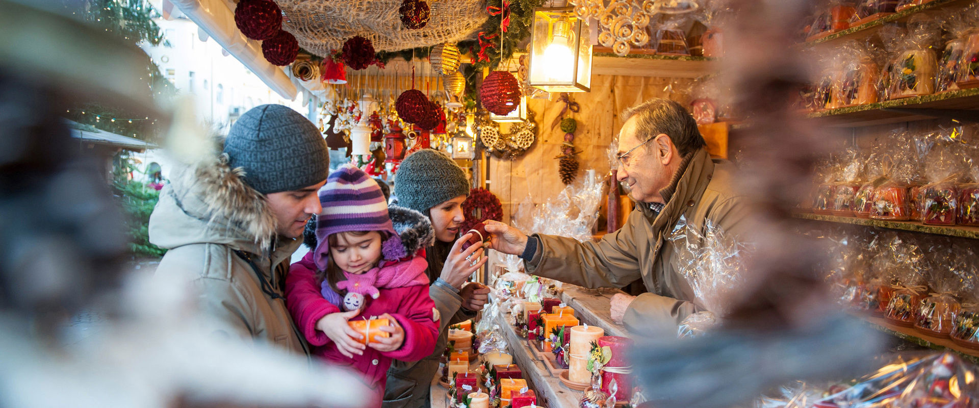 Christmas market stall with people.