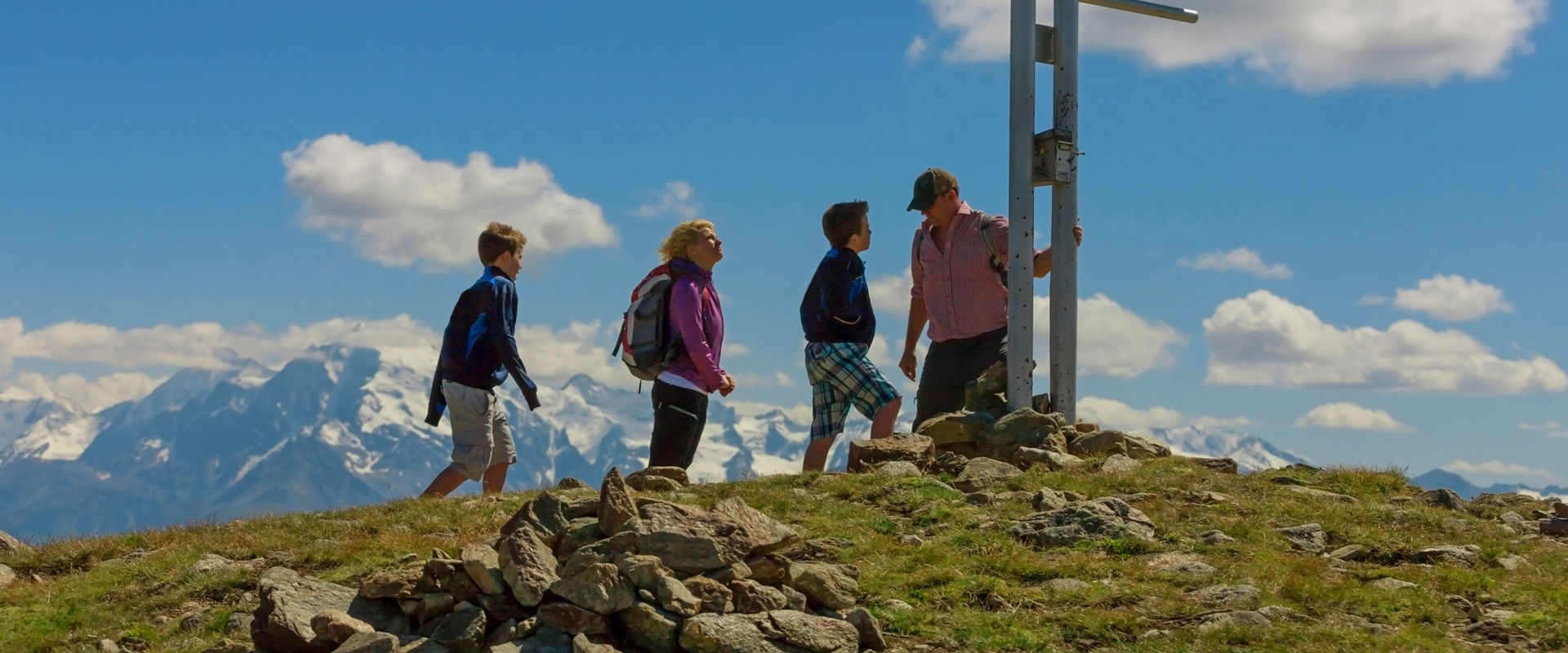 Watles summer hikes A family reaches the summit cross in Watles.