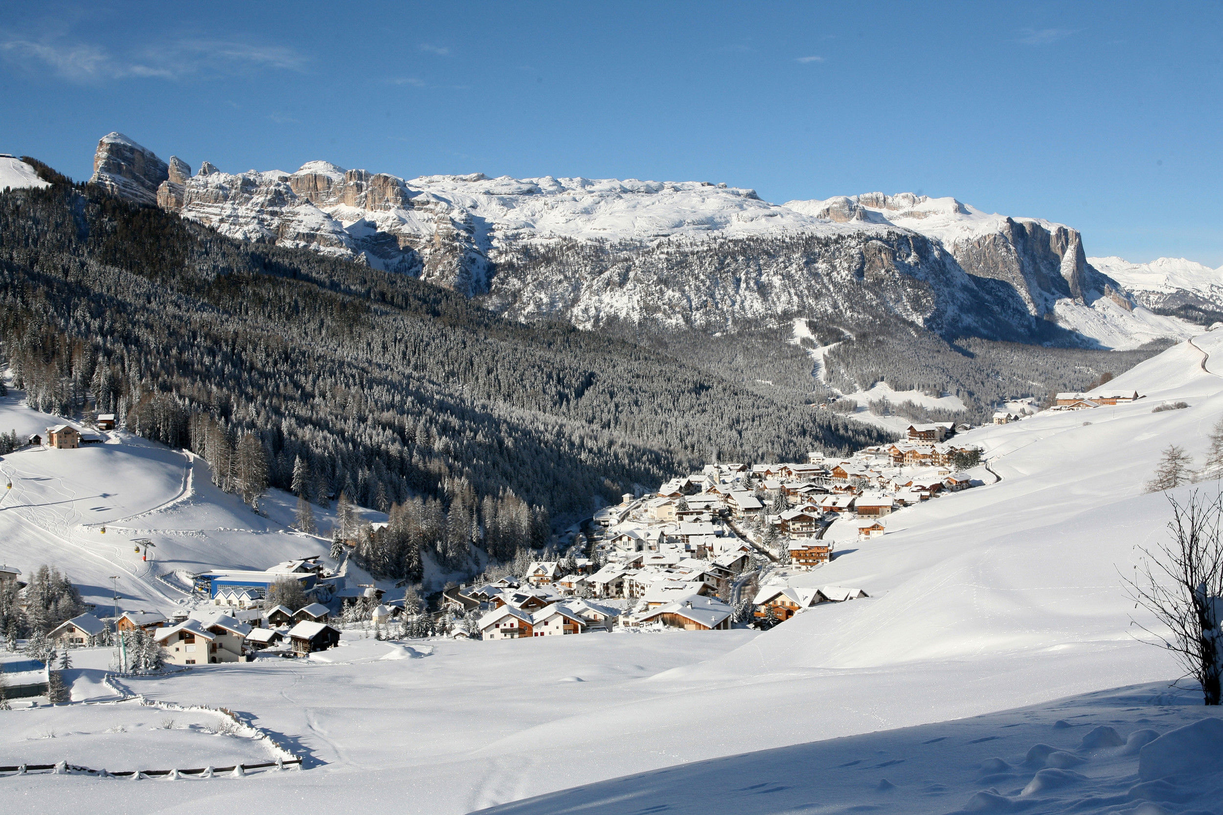 Village of St. Kassian in Alta Badia in winter with snow-covered Dolomites