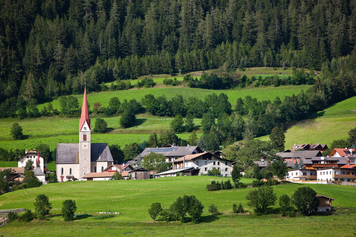Freienfeld with parish church in the middle of meadows