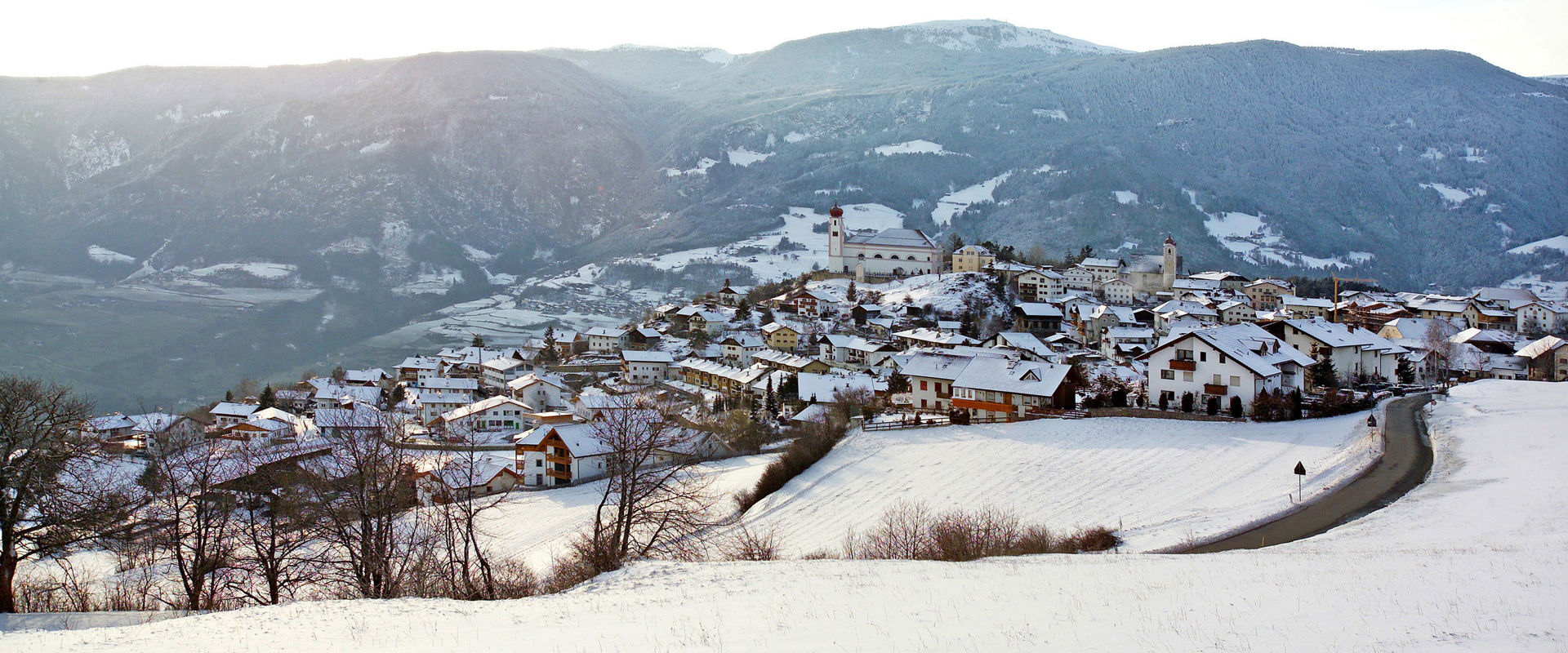 Lajen View of the snow-covered village of Lajen in winter