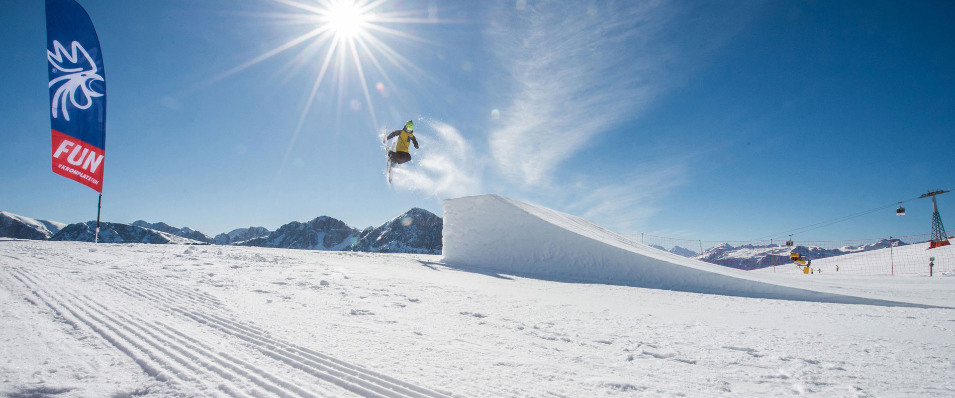 Kronplatz Snowpark Skier jumping over a ski jump at the Kronplatz Snowpark.