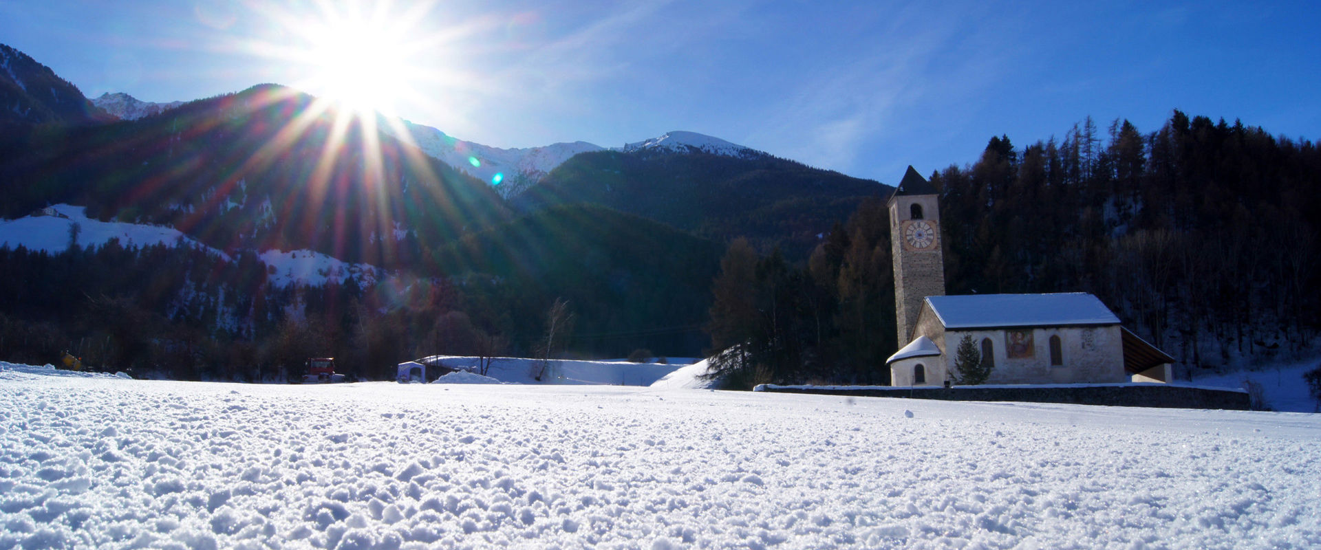 Lichtenberg in Prad am Stifserjoch. Snowy landscape with church.