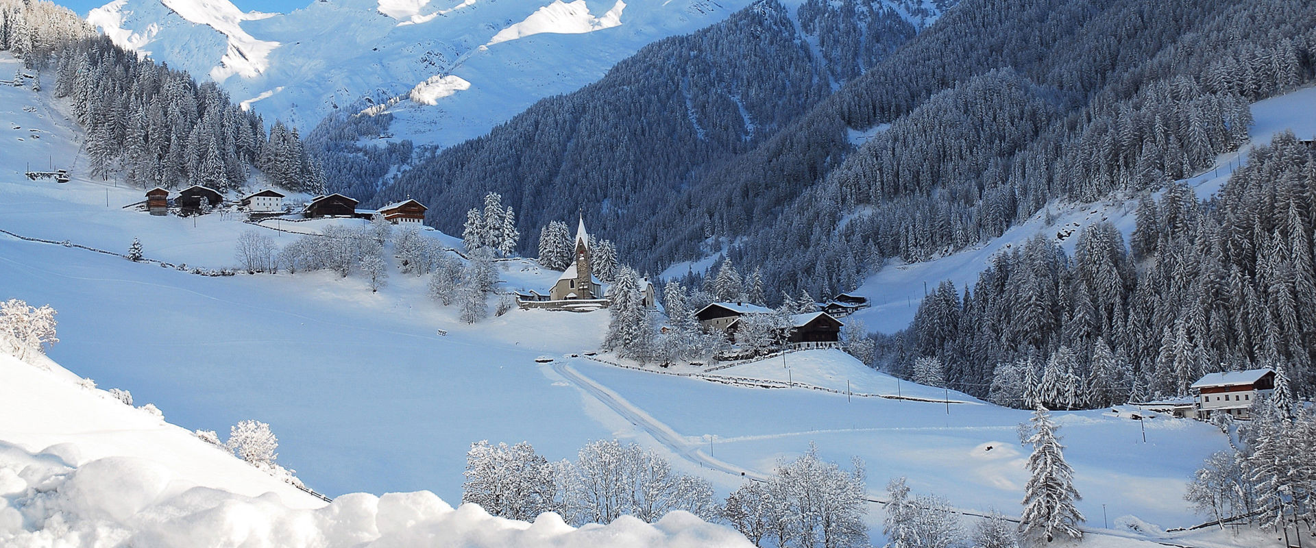 St. Peter in the Ahrntal Valley View of some houses in St. Peter in the Ahrntal Valley with surrounding snowy landscape