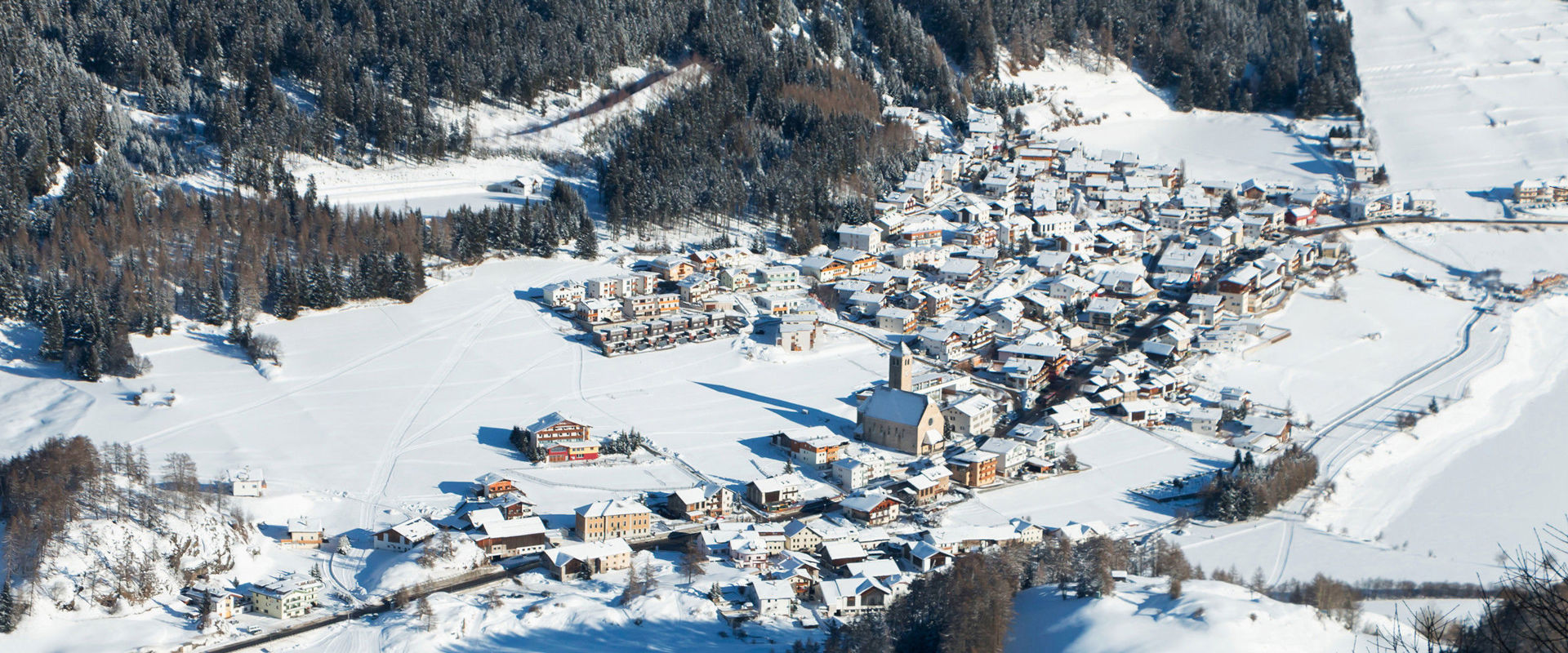 Reschen in a wintry atmosphere. The village of Reschen seen from above and covered in snow.