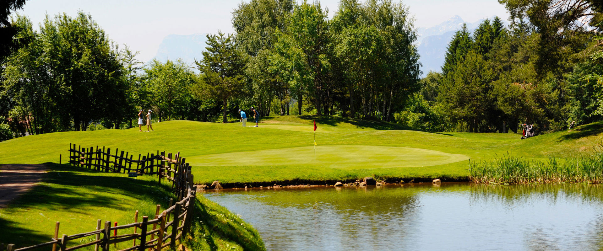 Golf Club Petersberg Golfers on the golf course under a bright blue sky.
