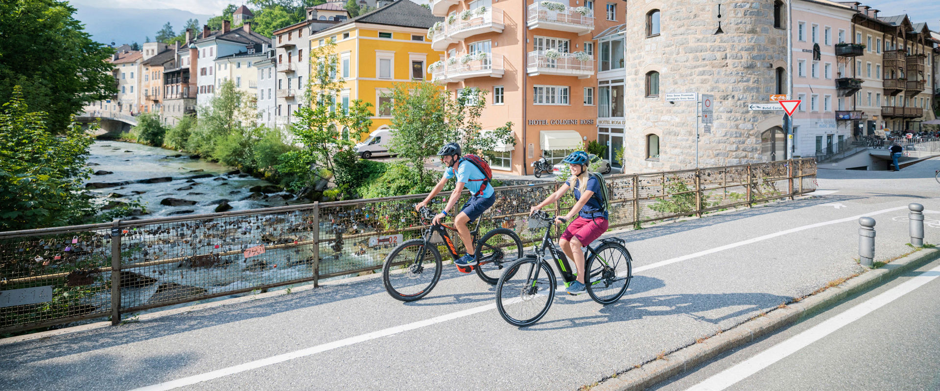 Cycle paths in Bruneck. 2 cyclists are on the road in the centre of Bruneck.