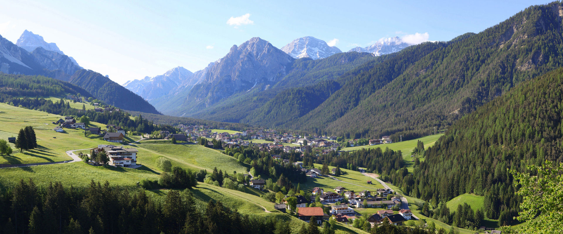St. Vigil in Enneberg with woods & meadows and the Dolomites