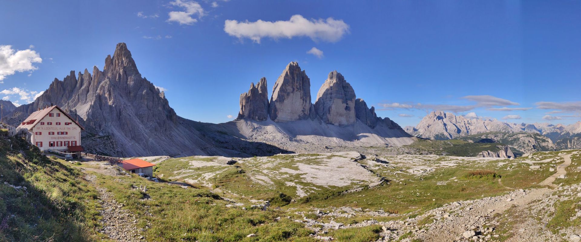 Opening hours of the toll road to the Auronzo hut during summer. Panoramic view of the 3 Peaks and the Auronzo hut.