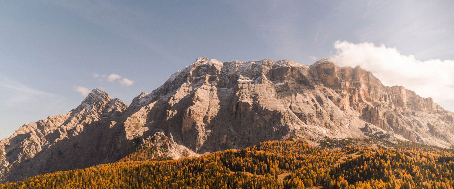 Heiligkreuzkofel Mt. Heiligkreuzkofel and golden-coloured woods in autumn