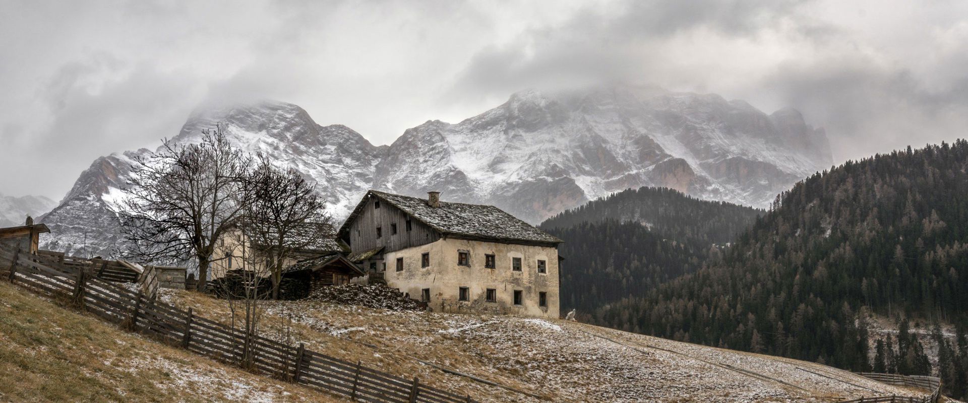 Wengen Old farm with fenced meadow and snowy mountains