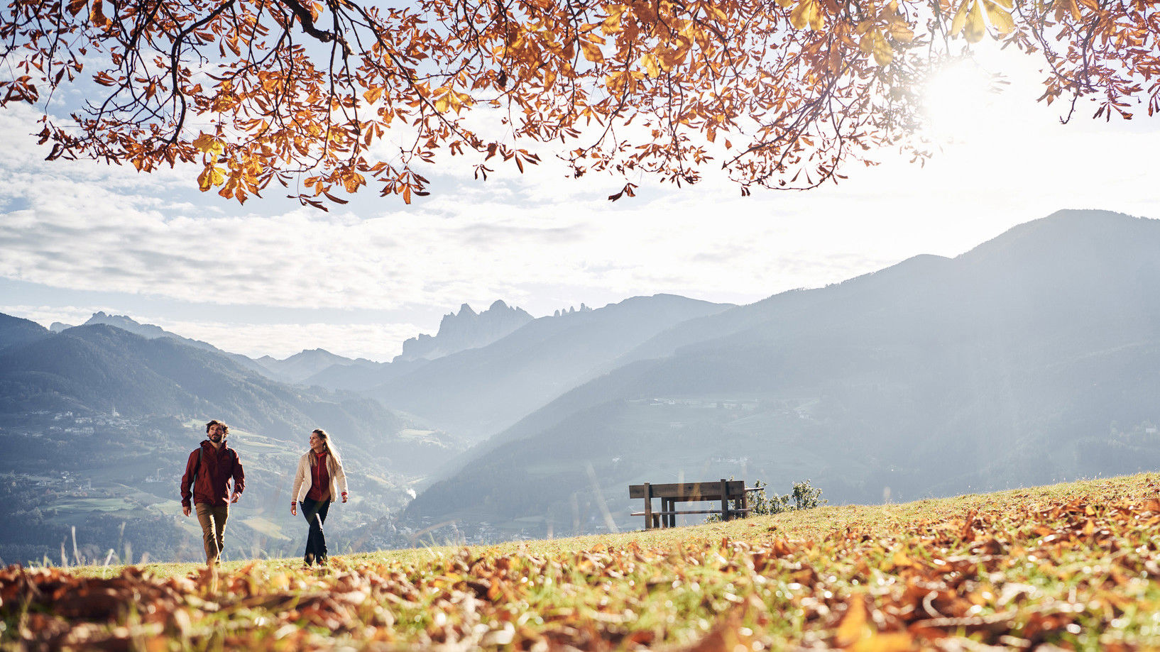 Man and woman take a walk in the autumn landscape.