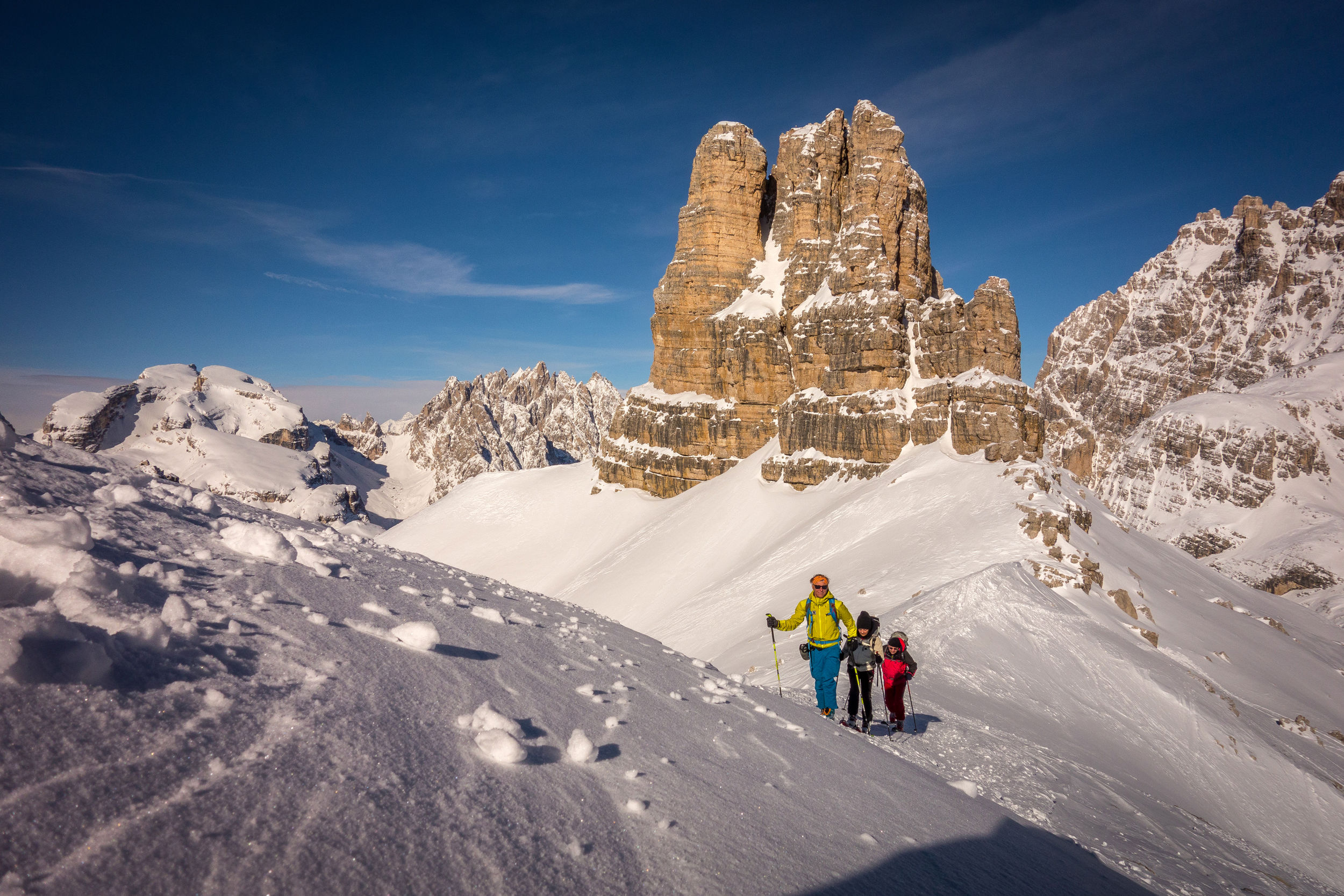 Ski tourers on the ascent of the Sextnerstein. In the background, one of the Three Peaks.