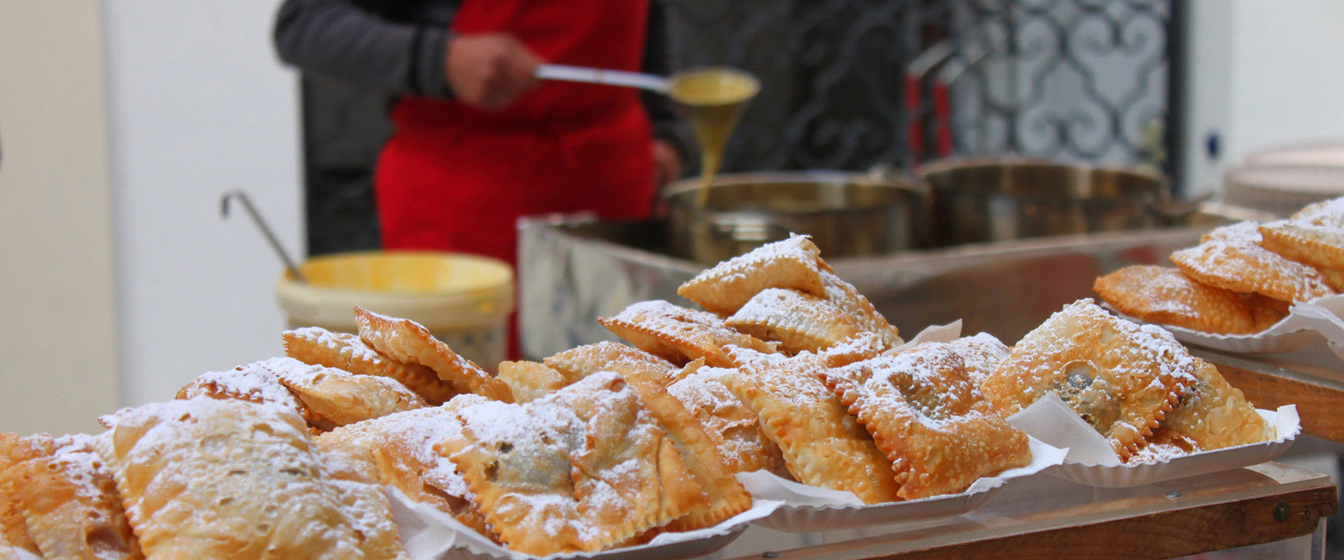 Doughnuts are displayed on a table for sale.