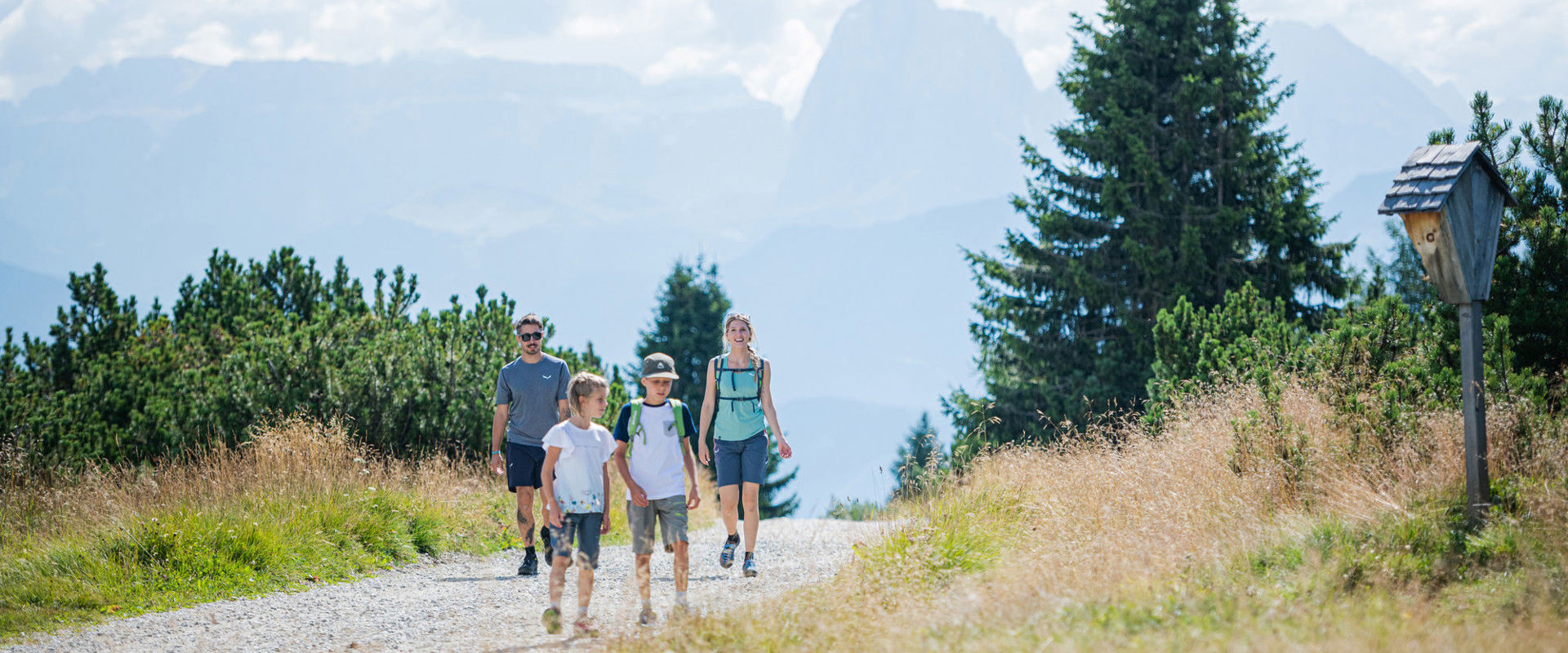 Hiking family on Villanderer Alm pasture
