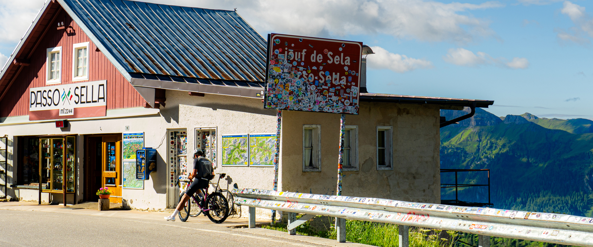 Sellajoch Pass Road sign and mountain hut on the Sella Pass road