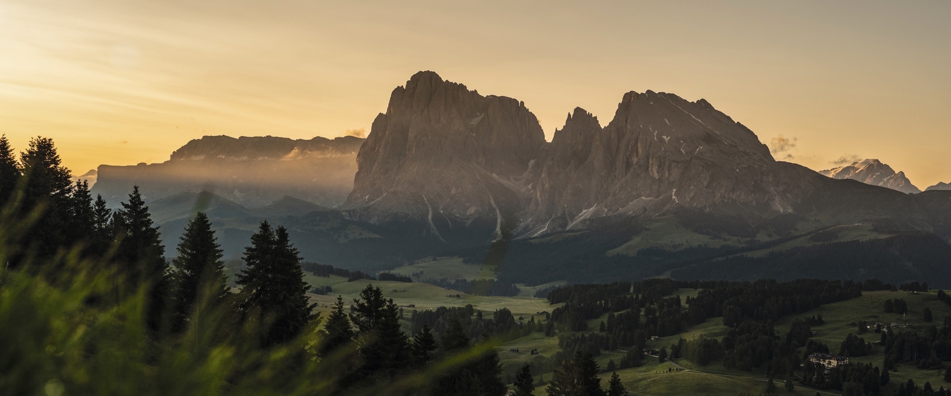 The gently rolling, green landscape of the Seiser Alm plateau, with a mountain range at its centre