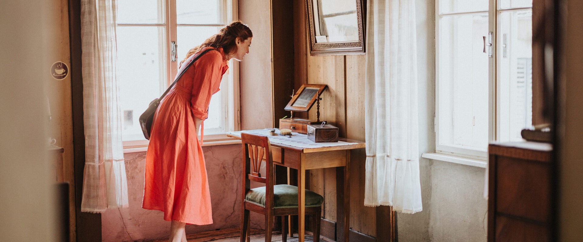 Woman in museum for everyday culture with antiques