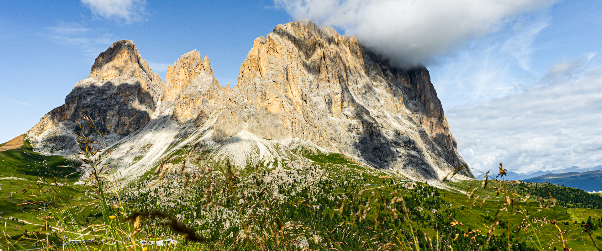 Langkofel with mountain meadow and clouds