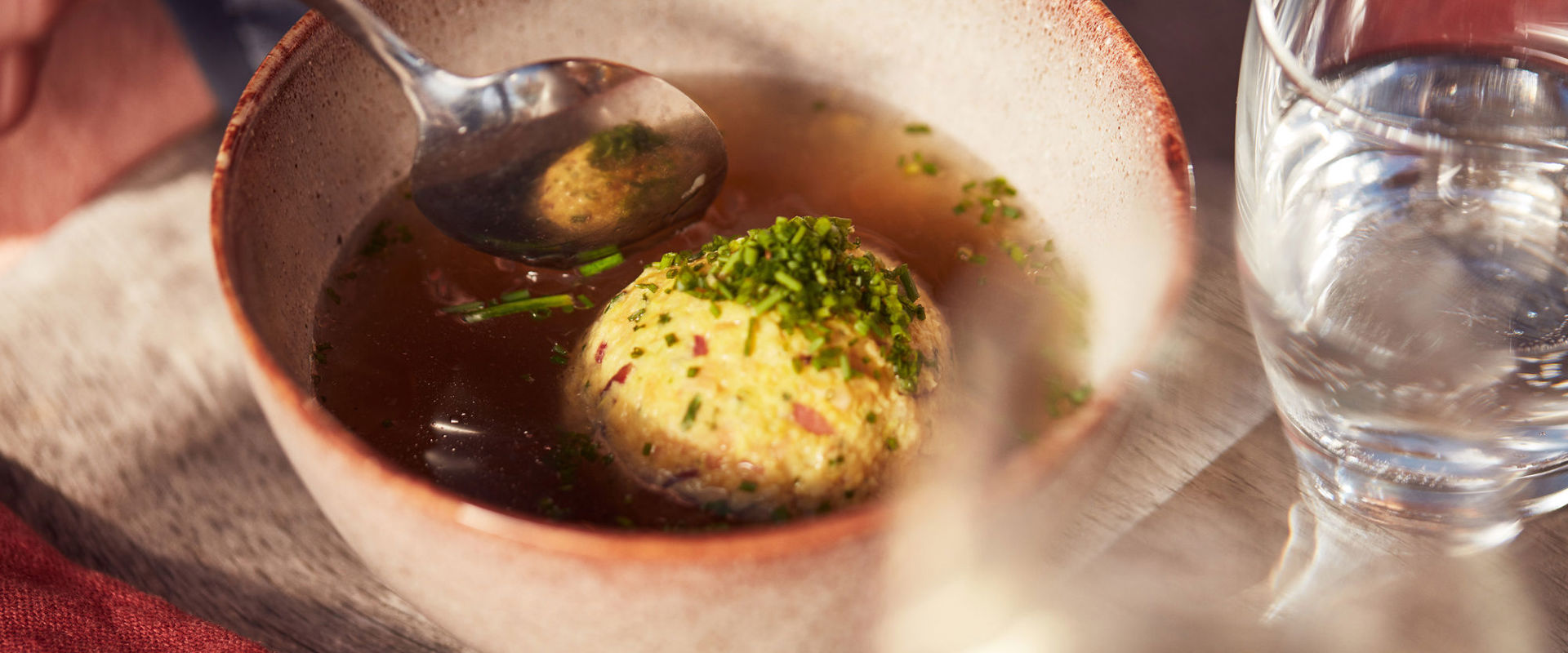 Bowl of soup with a dumpling.