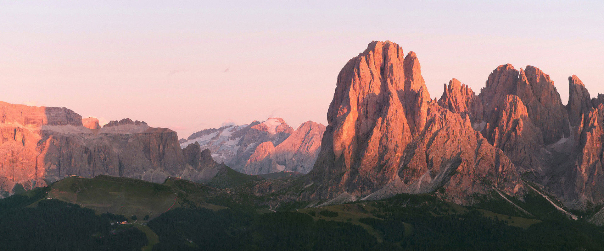Alpenglow. The setting or rising sun colours the Dolomites from reddish to violet.
